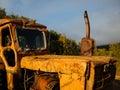 An old rusty orange tractor with dents and scratches Royalty Free Stock Photo