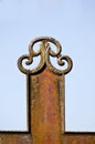 Old rusty ornamental metal cross fragment