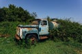 Old rusty overgrown truck. Abandoned Soviet tank car in ghost town Royalty Free Stock Photo