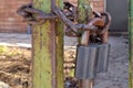 An old, rusty padlock with a chain hanging from the gate Royalty Free Stock Photo