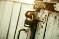 An old rusty padlock closes the wooden old gate on a sunny day. Safety Royalty Free Stock Photo