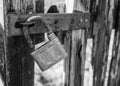 old rusty padlock on the door black and white photography Royalty Free Stock Photo