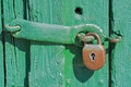 Old Rusty Padlock on Green Wooden Door Royalty Free Stock Photo