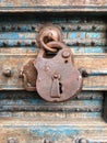 Old rusty padlock hanging on a dilapidated wooden door Royalty Free Stock Photo