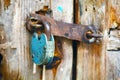 Old rusty padlock hanging on an old wooden door Royalty Free Stock Photo