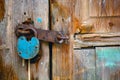 Old rusty padlock hanging on an old wooden door Royalty Free Stock Photo