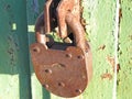 An old rusty padlock hangs on a metal gate. The concept of protection Royalty Free Stock Photo