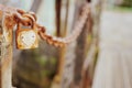 Old rusty padlock with heart shape on a metal chain, selective focus. Town folklore and legend concept Royalty Free Stock Photo