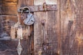 Old rusty padlock and latch on a wooden door Royalty Free Stock Photo