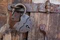 Old rusty padlock and latch on a wooden door Royalty Free Stock Photo