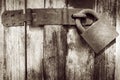 Old rusty padlock on old wooden door Royalty Free Stock Photo