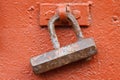 Old rusty padlock on a red iron door Royalty Free Stock Photo