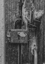 Old rusty padlock on a shabby wooden door. Royalty Free Stock Photo