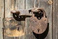 Old rusty padlock on wood brown door