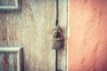 Old and rusty padlock on a wooden door Royalty Free Stock Photo
