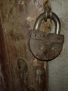 Old rusty padlock on an old wooden door Royalty Free Stock Photo