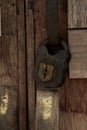 Old rusty padlock on wooden door Royalty Free Stock Photo