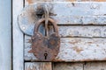 Old rusty padlock on a wooden door Royalty Free Stock Photo