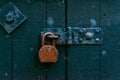 Old rusty padlock on wooden doors, old green destroyed door,safety Royalty Free Stock Photo