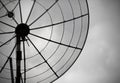 Old parabolic antenna on sky background