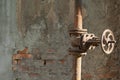 Old rusty pipe with valve on shabby brich wall background with free space for text, close-up Royalty Free Stock Photo