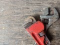 old rusty pipe wrench and adjustable wrench with wood texture background Royalty Free Stock Photo