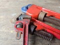 old and rusty pipe wrench in few size on a wood background Royalty Free Stock Photo