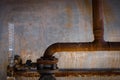 Old and rusty pipes and metal water tank with vertical guage Royalty Free Stock Photo