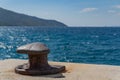 Old rusty place in the dock for ships rope mooring Royalty Free Stock Photo