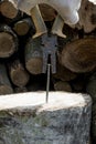 Old rusty pliers pull a new iron nail out of a stump. Hand in a work glove. Royalty Free Stock Photo