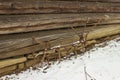 Old rusty plough in snow and wooden cabin