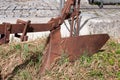 An old rusty ploughshare in a garden