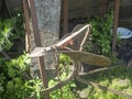 An old rusty plow lies in the grass on a Sunny summer day Royalty Free Stock Photo