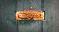 Old rusty Portuguese mailbox on a worn wooden door Royalty Free Stock Photo