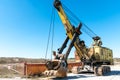 an old rusty quarry excavator is located on the territory of a mining quarry. an open method of mining