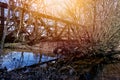 Old rusty railroad bridge over the river Ise near Gifhorn, Germany, is overgrown by trees and bushes Royalty Free Stock Photo