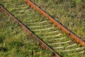 Old rusty railtracks in green grass Royalty Free Stock Photo