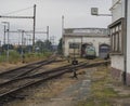 Old rusty railway station with train depot and rail tracks Royalty Free Stock Photo