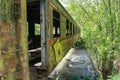 Old rusty railway wagon used as bridge over the river Royalty Free Stock Photo