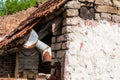 Old and rusty rain gutter on abandoned house damaged by age and water close up