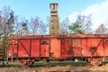 Old rusty red metal freight car on disused train tracks at old station Royalty Free Stock Photo
