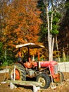 An old rusty red tractor with roof made of metal sheet put out in the outdoor Royalty Free Stock Photo