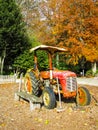 An old rusty red tractor with roof made of metal sheet put out in the outdoor Royalty Free Stock Photo