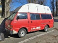 Old rusty red and white car camper van Mazda E series 2200 parked Royalty Free Stock Photo