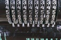 Old rusty retro calculator black standing on a wooden table Royalty Free Stock Photo