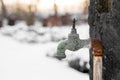 Old rusty retro outdoor garden faucet without valve outside in snowy garden Royalty Free Stock Photo