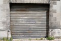 Old rusty roller garage gate access to house garage for a car rust grey dark door ancient building Royalty Free Stock Photo