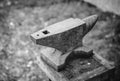 Old rusty rugged anvil on top blacksmith tools.