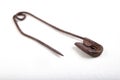 Old rusty safety pin for tailoring work. Accessories needed for sewing in a sewing room Royalty Free Stock Photo