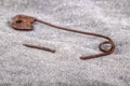 An old rusty safety pin for tailoring works in gray fabric. Accessories needed for sewing in a sewing room Royalty Free Stock Photo